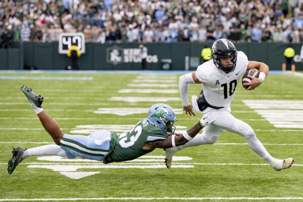 UCF quarterback John Rhys Plumlee (10) runs against Tulane safety Lummie Young IV (23) during an NCAA college football game in New Orleans, Saturday, Nov. 12, 2022. (AP Photo/Matthew Hinton)