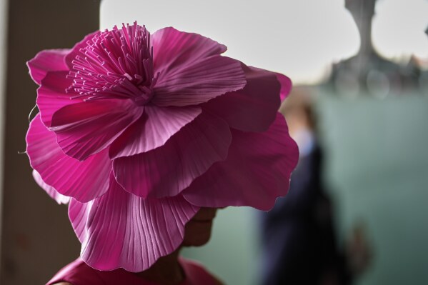 A race fan walk through the stands at Churchill Downs before the 151st running of the Kentucky Oaks horse race Friday, May 2, 2025, in Louisville, Ky. (AP Photo/Charlie Riedel)