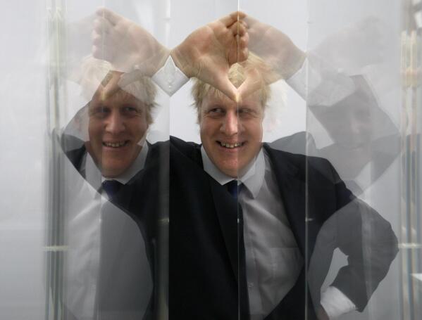 FILE - Boris Johnson, then Mayor of London looks through perspex as models of the next two commissions that will appear on the fourth plinth in Trafalgar Square are unveiled, in London, Friday, Jan. 14, 2011. He was the mayor who reveled in the glory of hosting the 2012 London Olympics, and the man who led the Conservatives to a whopping election victory on the back of his mission to “get Brexit done.” But Boris Johnson’s time as prime minister was marred by his handling of the coronavirus pandemic and a steady stream of ethics allegations. (AP Photo/Kirsty Wigglesworth, File)