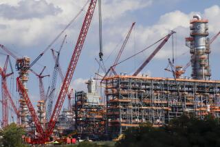 FILE —This file photo from Oct. 3, 2019 shows cranes as they work on construction of the Shell Pennsylvania Petrochemicals Complex and ethylene cracker plant located in Potter Township, Pa. Under mounting pressure from state and local officials, Shell announced it is suspending construction at its massive manufacturing complex in western Pennsylvania. The company said Wednesday, March, 18, 2020 that it's temporarily halting work at its soon-to-be-completed plant which will turn the area's vast natural gas deposits into plastics. The shutdown takes effect immediately. (AP Photo/Keith Srakocic, File)