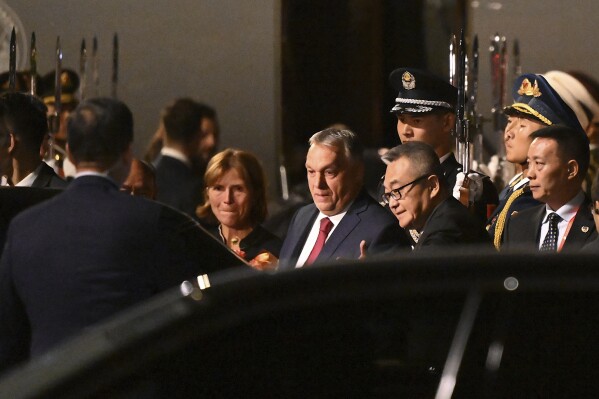 Hungarian Prime Minister Viktor Orban, centre, arrives at Beijing's airport ahead of the Belt and Road Forum in the Chinese capital on Sunday, Oct. 15, 2023. (Jade Gao/Pool Photo via AP)