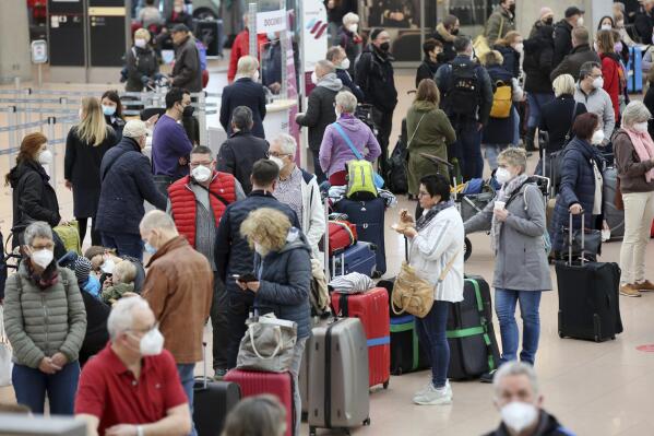 Numerous travelers wait in long lines at Hamburg Airport on Tuesday, March 15, 2022. Air travel was disrupted across Germany on Tuesday as security personnel at several airports in the country staged walkouts to demand higher wages.(Bodo Marks/dpa via AP)