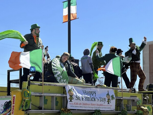 People celebrate the St. Patrick's Day parade on Sunday, March 17, 2024, in Kansas City, Mo. This year's theme was "50 Cheers for 50 Years." The parade marks one of the first mass gatherings following the deadly shooting at last month's Super Bowl champion Chiefs rally in Kansas City. (APhoto/Nick Ingram)