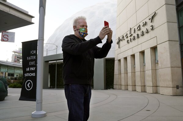 Movie trailer editor David Blanchard, a regular visitor to ArcLight Cinemas Hollywood, shoots video outside the closed theater complex, Monday, April 12, 2021, in Los Angeles. Pacific Theaters, whi...