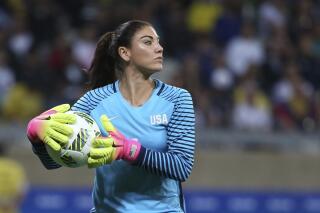 FILE - United States' goalkeeper Hope Solo takes the ball during a women's soccer game at the Rio Olympics against New Zealand in Belo Horizonte, Brazil, Aug. 3, 2016. Former U.S. women’s national team star goalkeeper Solo was arrested after police say she was found passed out behind the wheel of a vehicle in North Carolina with her two children inside. A police report said Solo was arrested on Thursday, March 31, 2022, in a shopping center parking lot in Winston-Salem and charged with driving while impaired, resisting a public officer and misdemeanor child abuse. (AP Photo/Eugenio Savio, File)