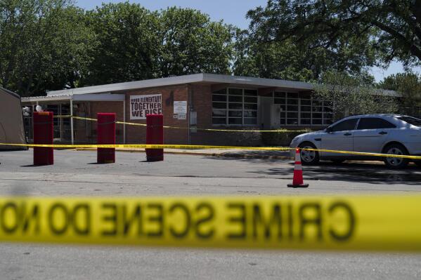 Crime scene tape surrounds Robb Elementary School in Uvalde, Texas, Wednesday, May 25, 2022. Desperation turned to heart-wrenching sorrow for families of grade schoolers killed after an 18-year-old gunman barricaded himself in their Texas classroom and began shooting, killing at least 19 fourth-graders and their two teachers. (AP Photo/Jae C. Hong)