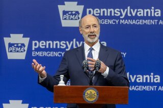 FILE - In this May 29, 2020, file photo, Pennsylvania Gov. Tom Wolf meets with the media at The Pennsylvania Emergency Management Agency (PEMA) headquarters in Harrisburg, Pa. A federal judge on Monday, Sept. 14 struck down Gov. Tom Wolf’s pandemic restrictions that required people to stay at home, placed size limits on gatherings and ordered “non-life-sustaining” businesses to shut down, calling them unconstitutional. (Joe Hermitt/The Patriot-News via AP, File)