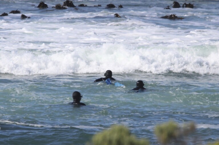 Poachers start to swim offshore at Pearly Beach, along the in Overberg District of South Africa in 2021. (Courtesy of Community Against Abalone Poaching via AP)