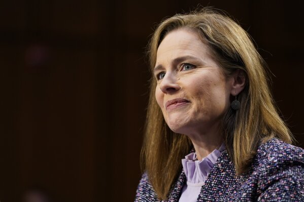 FILE - In this Oct. 14, 2020 file photo, Supreme Court nominee Amy Coney Barrett speaks during a confirmation hearing before the Senate Judiciary Committee, on Capitol Hill in Washington.  Supreme Court justice Amy Coney Barrett has delivered her first opinion.  The 7-2 decision released Thursday is in a case about the federal Freedom of Information Act, which Barrett explains makes “records available to the public upon request, unless those records fall within one of nine exemptions.” Barrett wrote for the court that certain draft documents do not have to be disclosed under FOIA.  The 11-page opinion comes in the first case Barrett heard after joining the court in late October following the death of Justice Ruth Bader Ginsburg.  Justice Stephen Breyer and Justice Sonia Sotomayor dissented. (AP Photo/Susan Walsh, Pool)