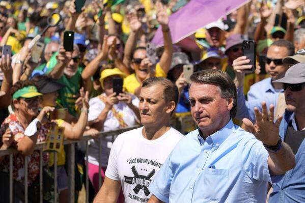 Brazil's President Jair Bolsonaro waves to supporters as he arrives at the Labor Day and Freedom rally, in Brasilia, Brazil, Sunday, May 1, 2022. (AP Photo/Eraldo Peres)