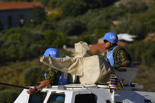 U.N. peacekeepers patrol on the Lebanese side of the Lebanese-Israeli border in the southern village of Kfar Kila, with the Israeli town of Metula in the background, Lebanon, Friday, Oct. 13, 2023. Sporadic acts of violence have been reported over the past days along the tense Lebanon-Israel border. (AP Photo/Bilal Hussein)