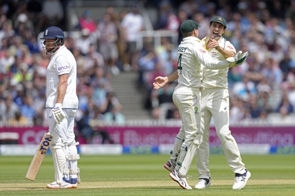 FILE - Australia's captain Pat Cummins, right, celebrates with teammate Alex Carey after the dismissal of England's Jonny Bairstow, left, during the fifth day of the second Ashes Test match between England and Australia, at Lord's cricket ground in London, Sunday, July 2, 2023. The Marylebone Cricket Club has expelled one member and handed long suspensions to two others following their clashes with Australia’s players during a spiky Ashes test at Lord’s in July. (AP Photo/Kirsty Wigglesworth, File)