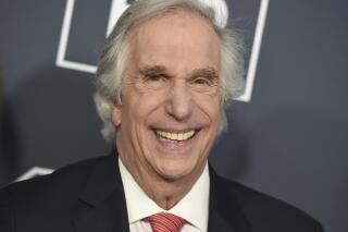 FILE — Henry Winkler arrives at the 25th annual Critics' Choice Awards, on Jan. 12, 2020, in Santa Monica, Calif. Celadon Books announced Wednesday that it has a deal with Winkler to tell his life story. The memoir, currently untitled, is scheduled for 2024. (Photo by Jordan Strauss/Invision/AP, File)