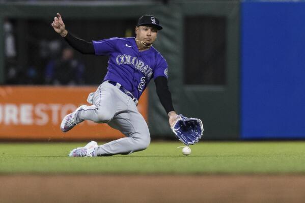 Colorado Rockies center fielder Yonathan Daza slides to field a ball against the San Francisco Giants during the fifth inning of a baseball game in San Francisco, Tuesday, May 10, 2022. (AP Photo/John Hefti)