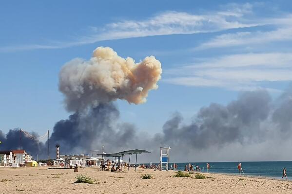 FILE - Rising smoke can be seen from the beach at Saky after explosions were heard from the direction of a Russian military airbase near Novofedorivka, Crimea, Aug. 9, 2022. A spate of drone attacks that Russian authorities blamed on Ukraine has targeted areas in southern and western Russia, reflecting the Ukrainian military's growing reach as the war dragged into a second year. (UGC via AP, File)