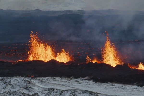 A close up of the Southern active segment of the original fissure of an active volcano in Grindavik on Iceland's Reykjanes Peninsula, Tuesday, Dec. 19, 2023. (AP Photo/Marco Di Marco)