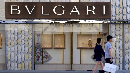 FILE - Shoppers walk past the Italian jewelry and luxury goods store, Bulgari in Beverly Hills, Calif, Thursday April 2, 2015. Italian luxury brand Bulgari is the latest international brand to apologize to China after listing Taiwan as a country on its website. (AP Photo/Richard Vogel, File)