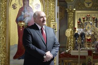 Belarusian President Alexander Lukashenko, left, attends the Orthodox Easter service in the town of Turov, some 270 km (167 miles) south of Minsk, Belarus, Sunday, May 2, 2021. (Maxim Guchek/BelTA Pool Photo via AP)