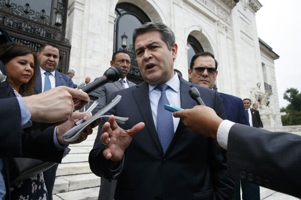 FILE - In this Aug. 13, 2019 file photo, Honduran President Juan Orlando Hernandez speaks to reporters as he leaves a meeting at the Organization of American States, in Washington. U.S. Federal prosecutors in New York said on Tuesday, March 9, 2021, that an accountant witnessed meetings between Hernández and a drug trafficker in which they planned the trafficking of cocaine to the U.S.  Hernández has previously denied any involvement with drug traffickers and has not been charged. (AP Photo/Jacquelyn Martin, File)
