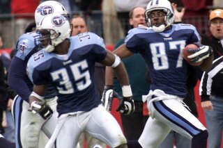 FILE - In this Jan. 8, 2000, file photo, Tennessee Titans wide receiver Kevin Dyson (87) looks back as he returns a kickoff in the fourth quarter during an AFC wild card football game in Nashville, Tenn. Blocking for Dyson are Perry Phenix (35) and Greg Favors (51). Dyson sped 75 yards down the left sideline with a lateral from Frank Wycheck on a kickoff for the winning touchdown with 3 seconds remaining, lifting the Tennessee Titans to a 22-16 playoff victory over the stunned Buffalo Bills. (AP Photo/Wade Payne, File)