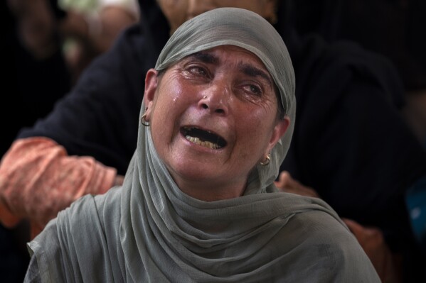 An unidentified relative of Waseem Sarvar Bhat, an Indian army solider who was killed in a gunfight with suspected rebels, grieves at his residence in Bandipora, north of Srinagar, Indian controlled Kashmir, Saturday, Aug. 5, 2023. Three Indian soldiers were killed in a gunbattle with rebels fighting against New Delhi's rule in Kashmir, officials said Saturday, as authorities stepped up security on the fourth anniversary since India revoked the disputed region's special status. (AP Photo/Dar Yasin)