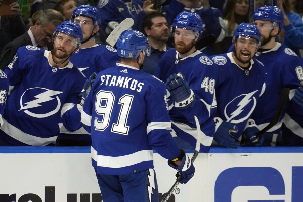 Tampa Bay Lightning center Steven Stamkos (91) celebrates with the bench after his goal against the Columbus Blue Jackets during the second period of an NHL hockey game Tuesday, April 9, 2024, in Tampa, Fla. (AP Photo/Chris O'Meara)
