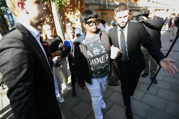 Renee Black, centre, mother of American rapper A$AP Rocky, leaves the district court in Stockholm, following the second day of testimony Thursday Aug. 1, 2019.  Pleading not guilty American rapper A$AP Rocky testified in court Thursday, as he stands on charges of assault.(Fredrik Persson / TT via AP)