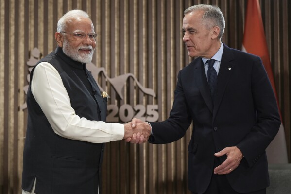 India's Prime Minister Narendra Modi, left, and Canada's Prime Minister Mark Carney shake hands during a meeting at the G7 Summit in Kananaskis, Alberta, Tuesday, June 17, 2025. (Darryl Dyck/The Canadian Press via AP)