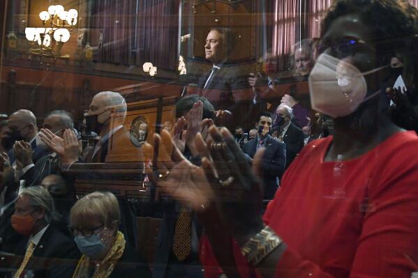 Connecticut Gov. Ned Lamont, center, reflected in a COVID-19 protection barrier, delivers the State of the State address during opening session at the State Capitol, Wednesday, Feb. 9, 2022, in Hartford, Conn. (AP Photo/Jessica Hill)
