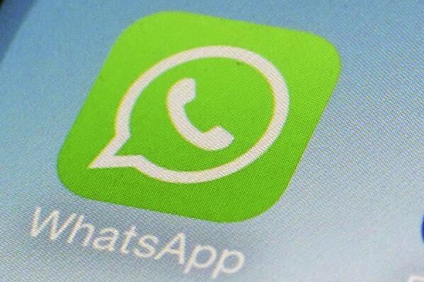 FILE - This Feb. 19, 2014, file photo, shows WhatsApp app icon on a smartphone in New York.  WhatsApp parent Meta is moving forward with its push to attract businesses to its popular chat app. Its part of an effort to find new ways to make money beyond targeted advertisements on its other platforms, Facebook and Instagram.  (AP Photo/Patrick Sison, File)