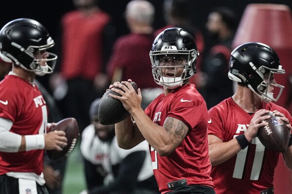 FILE - Atlanta Falcons quarterback Desmond Ridder (9) runs a drill during the the team's NFL minicamp football practice, Tuesday, June 13, 2023, in Atlanta. Ridder, a third-round pick in 2022, will be in the spotlight as the Falcons open training camp looking to end a string of five consecutive losing seasons. (AP Photo/John Bazemore, File)
