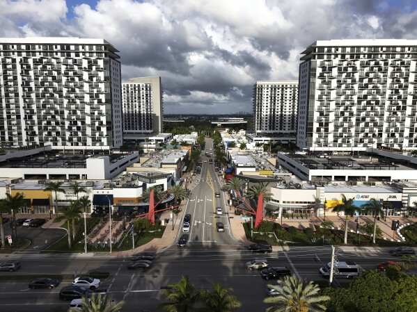 Cars pass through the area known as Downtown Doral, April 5, 2025, in Doral, Fla. (AP Photo/Rebecca Blackwell, File)