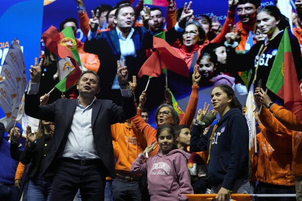 Luis Montenegro, leader of the center-right Democratic Alliance coalition, reacts to his supporters during a rally to close the election campaign in Lisbon, Friday, March 8, 2024. (AP Photo/Armando Franca)