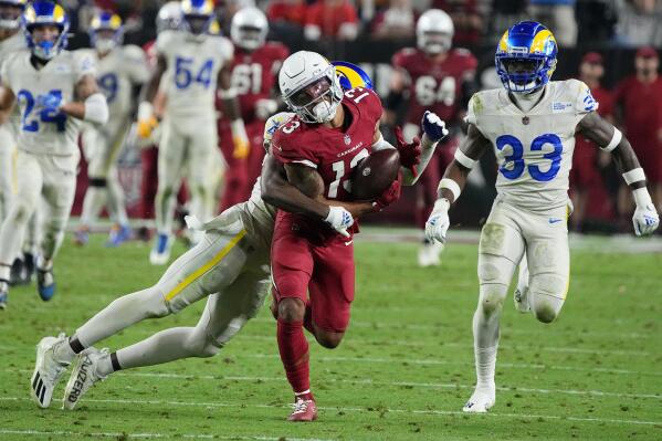 Arizona Cardinals wide receiver Christian Kirk (13) hauls in a long pass against Los Angeles Rams safeties Jordan Fuller (4) and Nick Scott (33) during the second half of an NFL football game Monday, Dec. 13, 2021, in Glendale, Ariz. (AP Photo/Rick Scuteri)