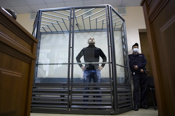 FILE - Andrei Pivovarov, the former head of the Open Russia movement, stands behind glass during a court session in Krasnodar, Russia, on June 2, 2021. (AP Photo, File)