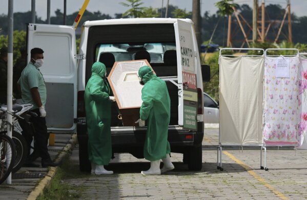 Funeral workers lift an empty coffin destined for victims of COVID-19 at the Joao Lucio Hospital in Manaus, Amazonas state, Brazil, Friday, April 17, 2020. (AP Photo/Edmar Barros)