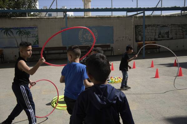 Students participate in physical education at the UNRWA Boys' School run by the U.N. agency for Palestinian refugees in the Shuafat Refugee Camp in east Jerusalem, Tuesday, April 29, 2025. (AP Photo/Maya Alleruzzo)