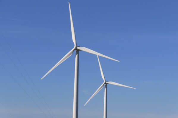 Land-based wind turbines spin in Atlantic City N.J. on Nov. 3, 2023. On Friday, Nov. 17, New Jersey utility regulators voted to seek bids for an energy transmission project to help bring power from ocean-based turbines to the onshore electrical grid. (AP Photo/Wayne Parry)