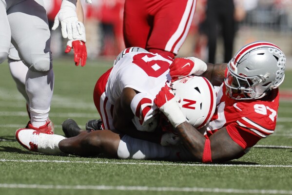 Ohio State defensive lineman Kenyatta Jackson, right, tackles Nebraska receiver Jaylen Lloyd for a loss during the first half of an NCAA college football game Saturday, Oct. 26, 2024, in Columbus, Ohio. (AP Photo/Jay LaPrete)
