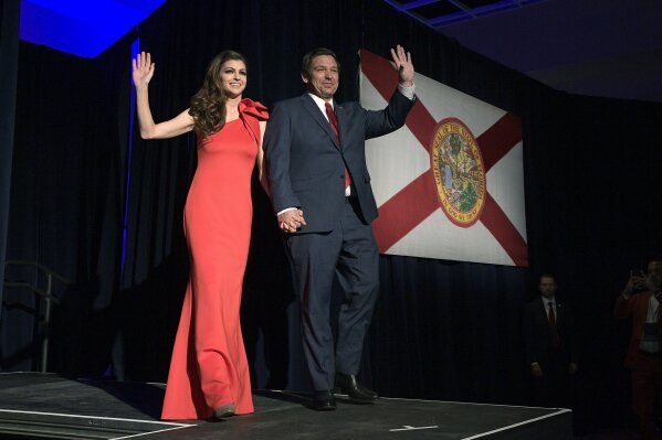
              Florida Gov.-elect Ron DeSantis, right, and his wife Casey wave to supporters as they walk onto the stage after he was declared the winner of the election at his party Tuesday, Nov. ...