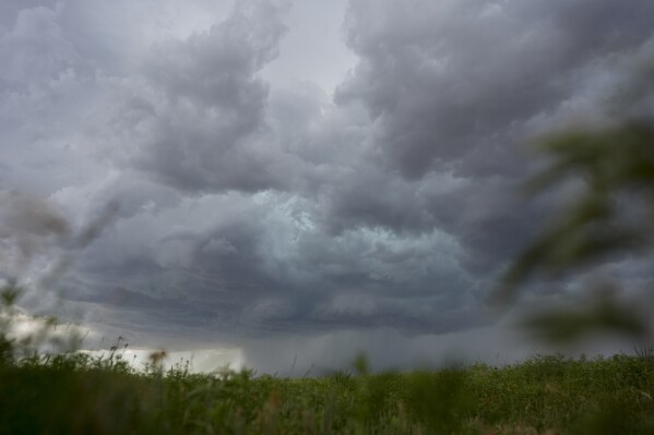 An approaching storm and rain shaft is visible during a Project ICECHIP operation Tuesday, June 3, 2025, near Tipton, Okla. (AP Photo/Carolyn Kaster)