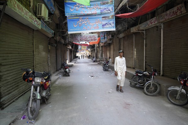 Pakistani shopkeepers close their businesses during strike against inflation in Lahore, Pakistan, Saturday, Sept. 2, 2023. Pakistani traders on Saturday went on strike against the soaring cost of living, including higher fuel and utility bills and record depreciation of the rupee against the dollar, which has led to widespread discontent among the public. (AP Photo/K.M. Chaudary)