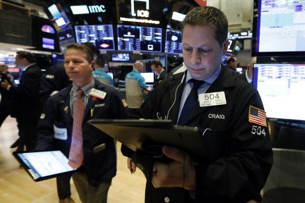 Trader Craig Esposito works on the floor of the New York Stock Exchange, Friday, March 6, 2020. Stocks are opening sharply lower on Wall Street and bond yields are sinking to more record lows as investors fear that economic damage from the spreading coronavirus outbreak will be longer than previously thought. (AP Photo/Richard Drew)