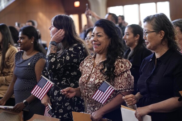 FILE - Women representing more than 20 countries take part in a Naturalization Ceremony, March 8, 2024, in San Antonio. More than half of the foreign-born population in the United States lives in just four states — California, Texas, Florida and New York — and their numbers grew older and more educated over the past dozen years, according to a new report released Tuesday, April 9, 2024, by the U.S. Census Bureau. (AP Photo/Eric Gay, File)