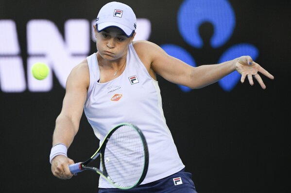 Australia's Ash Barty hits a backhand return to Russia's Ekaterina Alexandrova during their third round match at the Australian Open tennis championship in Melbourne, Australia, Saturday, Feb. 13, 2021.(AP Photo/Andy Brownbill)