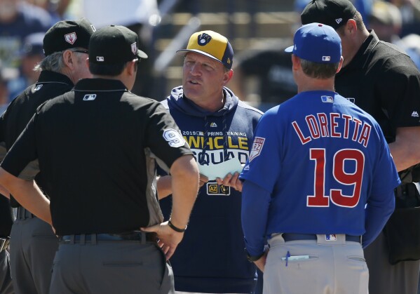 FILE - Milwaukee Brewers bench coach Pat Murphy, center, talks with Chicago Cubs bench coach Mark Loretta (19) and the umpires before a spring training baseball game Sunday, March 10, 2019, in Phoenix. After spending the last eight seasons as Craig Counsell’s bench coach, Murphy is taking over for his former boss as the Brewers’ manager, the baseball lteam announced, Wednesday, Nov. 15, 2023, just over a week after the Chicago Cubs announced they had hired Counsell away from Milwaukee. (AP Photo/Sue Ogrocki, File)