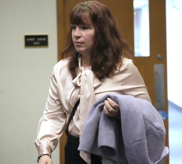 FILE - Kimberly Zapata, the former deputy director of the Milwaukee Election Commission, enters court before her jury trial at the Milwaukee County Courthouse in Milwaukee, March 18, 2024. A prosecutor urged jurors Wednesday, March 20, to find the former Milwaukee elections official who requested fake absentee ballots guilty of misconduct and fraud, rejecting her argument that she was only trying to expose flaws in Wisconsin's election system. (Mike De Sisti/Milwaukee Journal-Sentinel via AP, File)