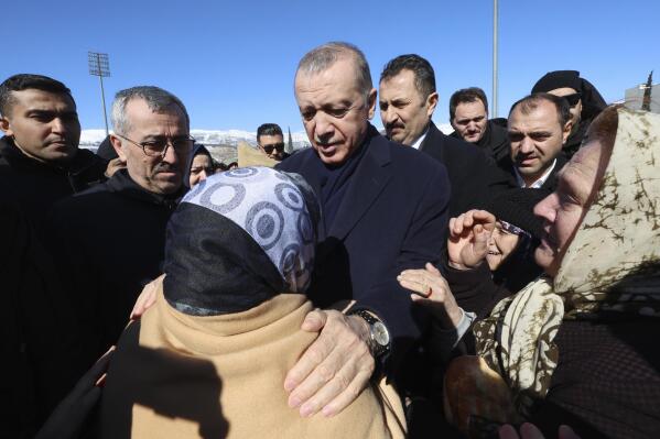 FILE - Turkey's President Recep Tayyip Erdogan and a survivor speak as he visits the city center destroyed by Monday earthquake in Kahramanmaras, southern Turkey, Wednesday, Feb. 8, 2023. Turkish President Recep Tayyip Erdogan came to power 20 years ago riding a wave of public outrage toward the previous government's handling of a deadly earthquake. Now, three months away from an election, Erdogan's political future hinges on how the public perceives his government's response to a similarly devastating natural disaster. (Turkish Presidency via AP, File)
