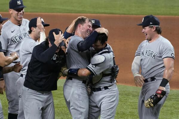 New York Yankees starting pitcher Corey Kluber, third from right, celebrates with catcher Kyle Higashioka, second from right, and the rest of the team after throwing a no-hitter against the Texas Rangers in a baseball game in Arlington, Texas, Wednesday, May 19, 2021. (AP Photo/Tony Gutierrez)