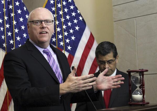 FILE - In this Feb. 25, 2015, file photo Rep. Joe Crowley, D-N.Y. left, accompanied by Rep. Xavier Becerra, D-Calif., gestures during news conference on Capitol Hill in Washington. Opposition from some leading moderate Democrats over a $3.5 trillion budget proposal championed by the party's most-liberal, progressive wing has left the party grappling with deeper ideological questions. “This is critically important for Democrats and for their message in next year’s election," said former New York congressman Joe Crowley, a veteran Democrat who was upset in the 2018 primary by progressive star, Rep. Alexandria Ocasio-Cortez. "We’re going to blink and we’re going to be in 2022.” (AP Photo/Lauren Victoria Burke, File)
